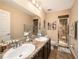 Double vanity bathroom with granite countertop and shower at 5025 Cactus Needle Ln, Wesley Chapel, FL 33544