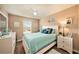 Light and bright bedroom with a queen bed and wood-look flooring at 5025 Cactus Needle Ln, Wesley Chapel, FL 33544