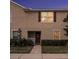 Well-maintained townhouse exterior with a walkway and landscaping at 5025 Cactus Needle Ln, Wesley Chapel, FL 33544