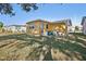 House backyard view with green grass and trees at 5430 Palm Crest N Ct, Pinellas Park, FL 33782