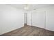 Bright bedroom with wood-look floors and spacious closet at 5430 Palm Crest N Ct, Pinellas Park, FL 33782