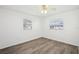 Bright bedroom with wood-look floors and ceiling fan at 5430 Palm Crest N Ct, Pinellas Park, FL 33782