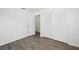 Bedroom featuring wood-look floors and a double door closet at 5430 Palm Crest N Ct, Pinellas Park, FL 33782