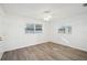 Simple bedroom with wood-look floors and ceiling fan at 5430 Palm Crest N Ct, Pinellas Park, FL 33782