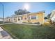 Ranch style home with a yellow exterior and neat landscaping at 5430 Palm Crest N Ct, Pinellas Park, FL 33782