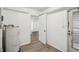 Laundry area with water heater, storage and exterior access at 5430 Palm Crest N Ct, Pinellas Park, FL 33782