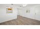 Living room with wood-look floors and kitchen peek at 5430 Palm Crest N Ct, Pinellas Park, FL 33782