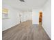 Open and bright living area with wood-look vinyl flooring at 5430 Palm Crest N Ct, Pinellas Park, FL 33782