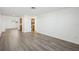 Open concept living room with kitchen view and vinyl flooring at 5430 Palm Crest N Ct, Pinellas Park, FL 33782