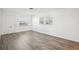 Bright living room with gray vinyl plank flooring and neutral walls at 5430 Palm Crest N Ct, Pinellas Park, FL 33782