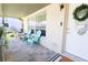 Relaxing front porch with teal chairs and decorative wreath at 7838 Avenal Loop, New Port Richey, FL 34655