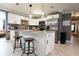 Modern kitchen with white cabinets, marble island, and stainless steel appliances at 7838 Avenal Loop, New Port Richey, FL 34655