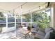 Relaxing screened porch with seating and grill at 7838 Avenal Loop, New Port Richey, FL 34655
