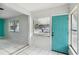 Front entry with teal door and tiled floor at 2901 Dr Martin Luther King Jr S St, St Petersburg, FL 33705