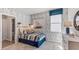Cozy bedroom with wood-like wall accents and en-suite bathroom at 1011 159Th E Way, Bradenton, FL 34212