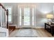 Bright entryway with hardwood floors and a stylish rug at 1044 Rosetree Ln, Tarpon Springs, FL 34689