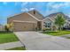 Two-story home with attached garage and landscaping at 10625 Park Meadowbrooke Dr, Riverview, FL 33578