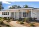 Front entrance of the home with a landscaped walkway at 11556 70Th Ter, Seminole, FL 33772