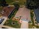 Aerial view of two houses with brown and gray roofs, green lawns, and a street at 13133 Golf Ridge Pl, Hudson, FL 34669