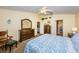 Main bedroom features king bed, dresser, and access to ensuite bath at 13133 Golf Ridge Pl, Hudson, FL 34669