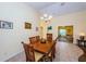 Dining room with a wooden table and chairs, open to living room at 13133 Golf Ridge Pl, Hudson, FL 34669