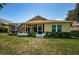 Back exterior of house showing screened porch at 13133 Golf Ridge Pl, Hudson, FL 34669