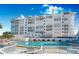 Community pool with plenty of seating and beach access at 1582 Gulf Blvd # 1208, Clearwater, FL 33767