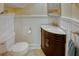 Charming half-bathroom with marble countertop, dark wood vanity, and beadboard paneling at 165 21St Ne Ave, St Petersburg, FL 33704