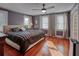 Primary bedroom with hardwood floors, a ceiling fan, and ample natural light through large windows at 165 21St Ne Ave, St Petersburg, FL 33704