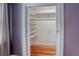 Walk-in closet with built-in shelves and hanging rods at 165 21St Ne Ave, St Petersburg, FL 33704