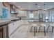 Bright eat-in kitchen features white cabinetry, stainless steel appliances, and a large island with stool seating at 165 21St Ne Ave, St Petersburg, FL 33704