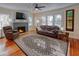 Cozy living room with a brick fireplace, hardwood floors, and a comfortable leather sofa at 165 21St Ne Ave, St Petersburg, FL 33704