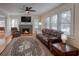 Cozy living room featuring a brick fireplace, hardwood floors, and comfortable leather seating at 165 21St Ne Ave, St Petersburg, FL 33704