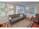 Bright sunroom with terracotta tile, neutral furniture, and large windows showcasing the outdoor scenery at 165 21St Ne Ave, St Petersburg, FL 33704