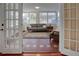 Sunroom view through french doors, showing neutral furniture, terracotta floors, and natural light at 165 21St Ne Ave, St Petersburg, FL 33704