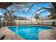 Inviting screened-in pool with tiled decking at 2018 Indian Rocks S Rd, Largo, FL 33774