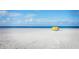 Beachfront property with a yellow beach tent and ocean view at 204 163Rd Ave, Redington Beach, FL 33708