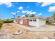 White and red brick home with a two-car garage and side yard at 204 163Rd Ave, Redington Beach, FL 33708