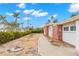 Side view of a mid-century modern home with a gravel yard at 204 163Rd Ave, Redington Beach, FL 33708