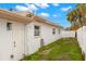 House exterior showcasing a side view, yard, and white fence at 204 163Rd Ave, Redington Beach, FL 33708