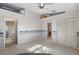 Bright bedroom with carpet flooring, a ceiling fan, and a view of a second room at 2997 60Th S Ave, St Petersburg, FL 33712