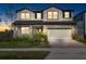 Two-story home with a neutral color palette and landscaping at 33157 Rosewood Bark Way, Wesley Chapel, FL 33545
