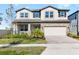 Two story home with a neutral color palette and landscaping at 33157 Rosewood Bark Way, Wesley Chapel, FL 33545