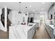 Modern kitchen with gray cabinets, large island, and quartz countertops at 33157 Rosewood Bark Way, Wesley Chapel, FL 33545
