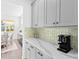 Butler's pantry with gray cabinets and quartz countertops at 33157 Rosewood Bark Way, Wesley Chapel, FL 33545