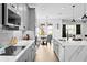 Bright kitchen featuring gray cabinets, stainless steel appliances, and an island at 33157 Rosewood Bark Way, Wesley Chapel, FL 33545