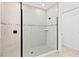 Spacious shower with glass enclosure and neutral tile at 33157 Rosewood Bark Way, Wesley Chapel, FL 33545