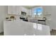 Modern kitchen with white cabinets, stainless steel appliances and quartz countertops at 3442 Desert Trunk Ct, Tampa, FL 33614