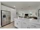 Stainless steel refrigerator in this modern kitchen with white cabinets at 3442 Desert Trunk Ct, Tampa, FL 33614