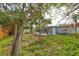 Backyard view showing home and screened porch at 5117 12Th S Ave, Gulfport, FL 33707